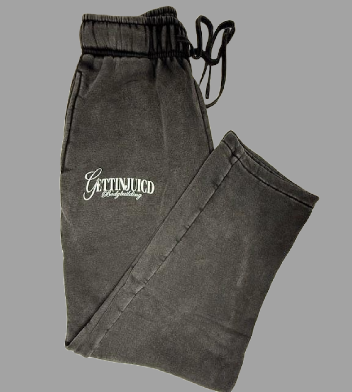 Flat lay of black GettinJuicd joggers with front logo and elastic waistband, folded for display.