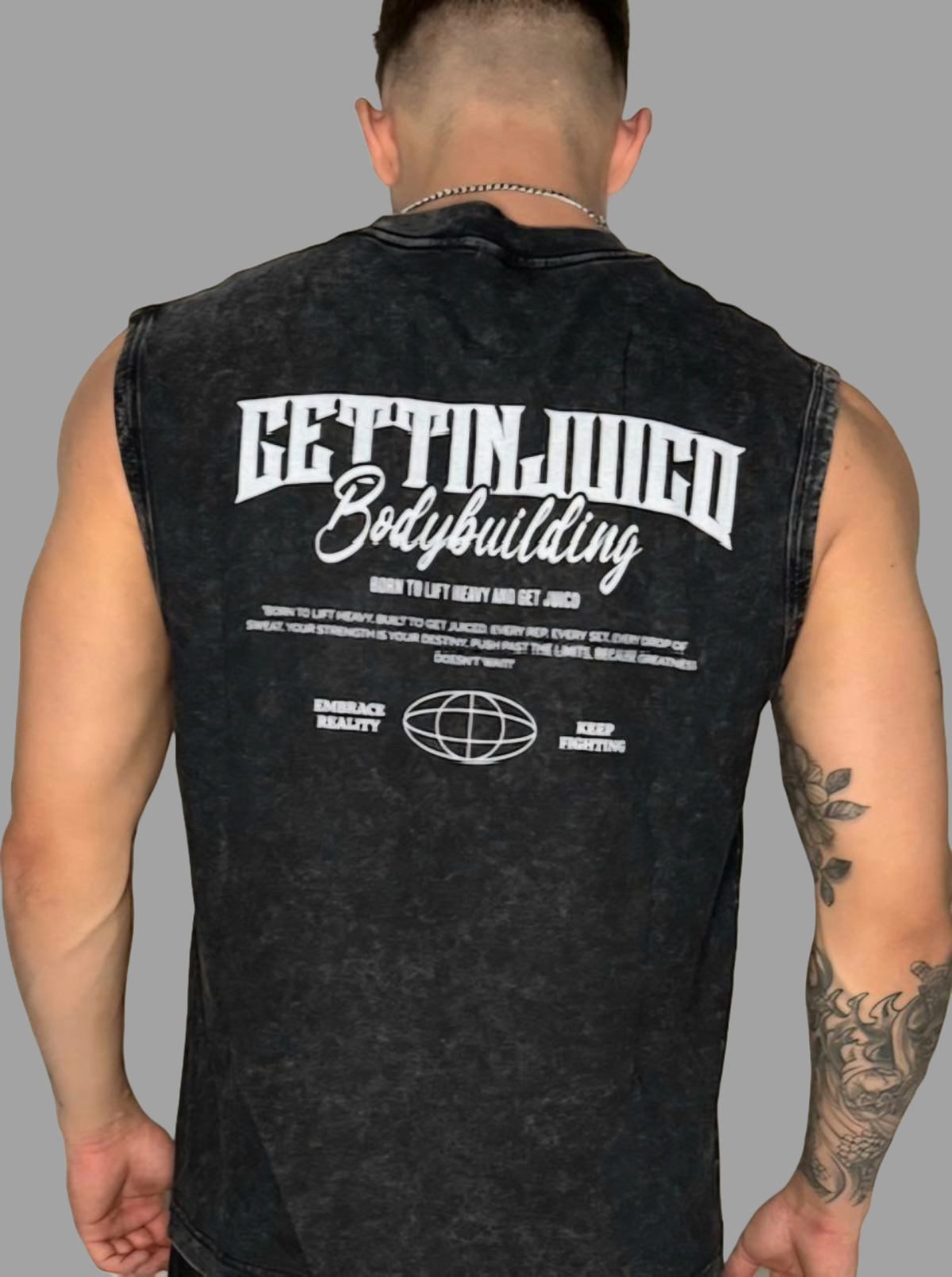 Back view of model wearing Embrace Reality men’s gym vest with bold GettinJuicd Bodybuilding print and motivational design.
