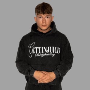 Front view of model wearing GettinJuicd athletic fit hoodie in acid-wash grey with front logo.