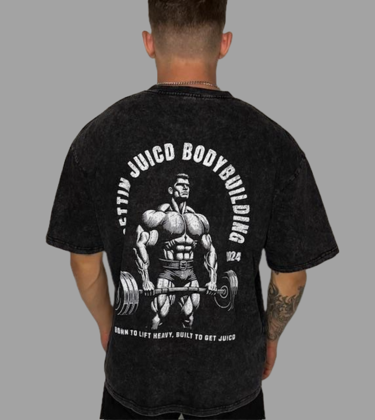 Model wearing Juicd Up workout t-shirt for men with bold bodybuilding graphic and slogan: Born to Lift Heavy, Built to Get Juicd.